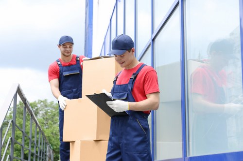 Removal staff loading items carefully near a Balham flat