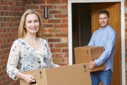 Professional movers handling boxes in a Balham flat move