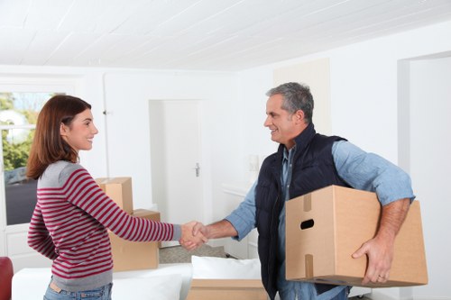 Professional movers carrying furniture during a same day relocation